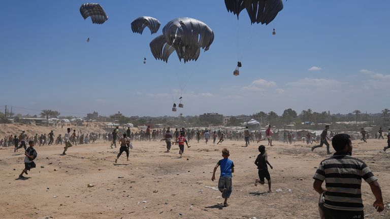 Palestinians rush to collect humanitarian aid in Gaza. Pic: AP