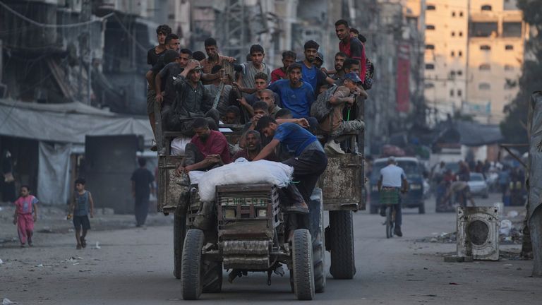 Palestinians ride a truck carrying humanitarian aid in Gaza City. Pic: AP