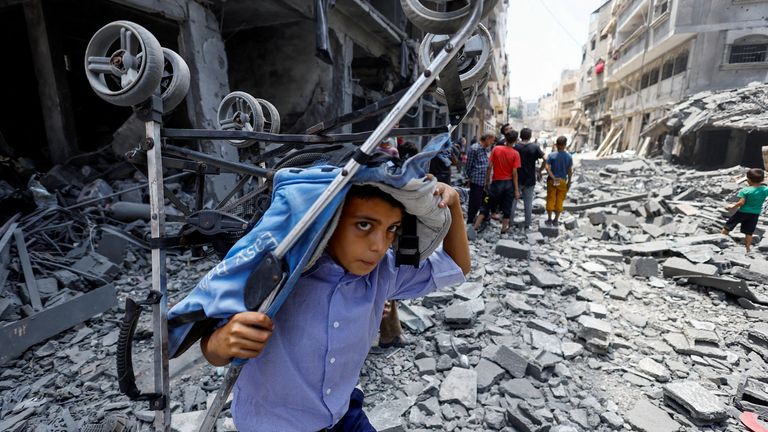 A Palestinian boy after an Israeli strike on a house in Gaza City on Friday. Pic: Reuters