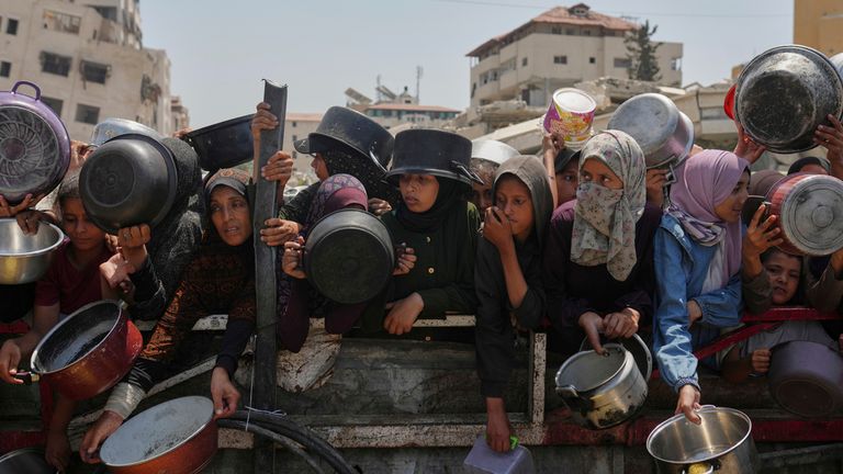 Palestinians struggle to get aid at a community kitchen in Gaza City. Pic: AP