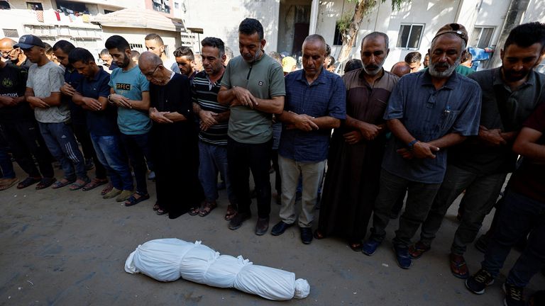 Mourners pray next to the body of Palestinian boy Hamada Abedrabo on 24 August. Pic: Reuters