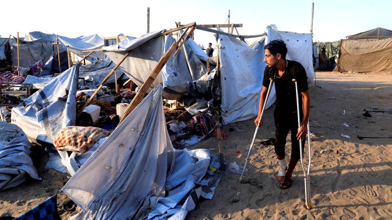 Palestinians inspect the damage at the site of an overnight Israeli strike  in Khan Younis.
Pic: Reuters