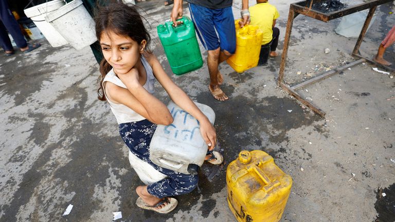 A girl waits for water in Gaza. Pic: Reuters