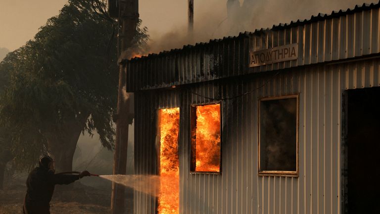 Fires burn homes and factories, forcing evacuations near Patras. Pic: Louiza Vradi/Reuters
