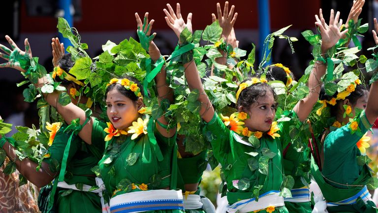 Schoolchildren dressed with tree leaves perform during Independence Day celebrations in Kolkata. Pic: AP