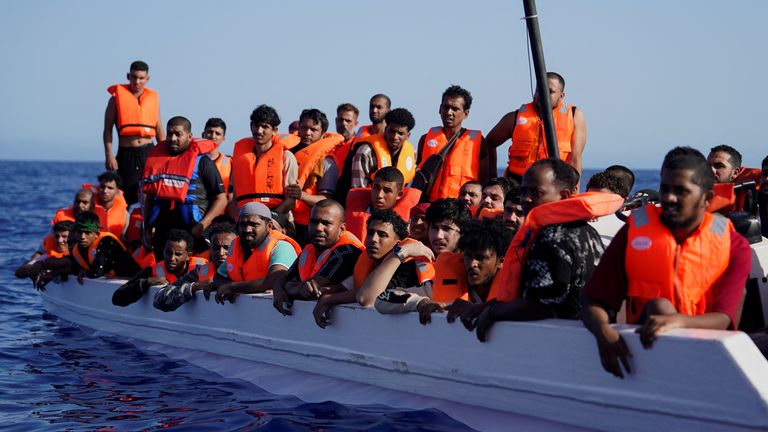 Migrants on a fibreglass boat off the coast of Lampedusa in July. Pic: Reuters