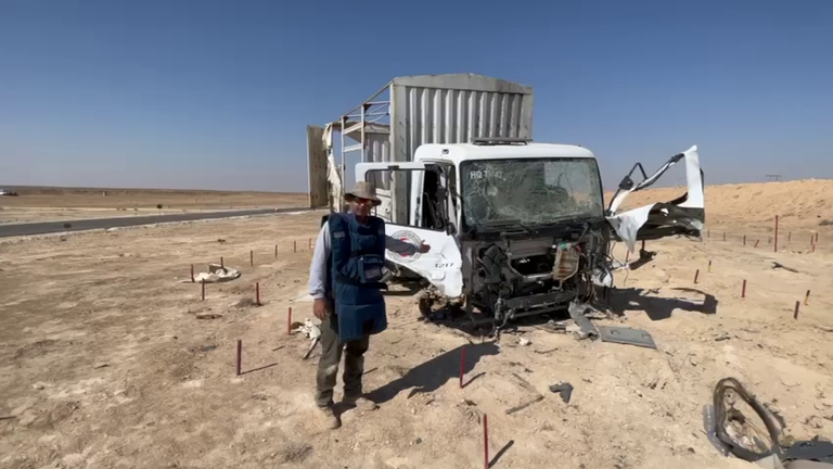 Sunil in front of a Red Crescent truck that hit a mine. Pic: MAG