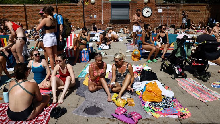 People sunbathe at London Fields Lido. Pic: Reuters