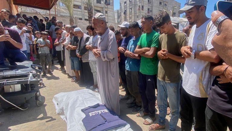 Relatives and friends pray over the body of journalist Mariam Dagga. Pic: AP