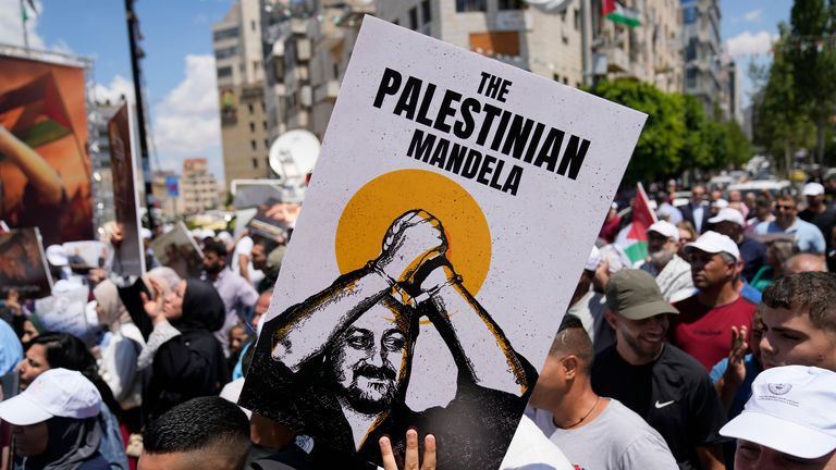 A protester in the West Bank holds a poster depicting Barghouti during a rally in solidarity with Gaza and prisoners held by Israel. Pic: AP