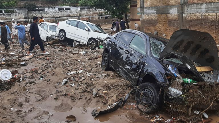 Cars are trapped in a mud after flash flooding in Mingora. Pic: AP