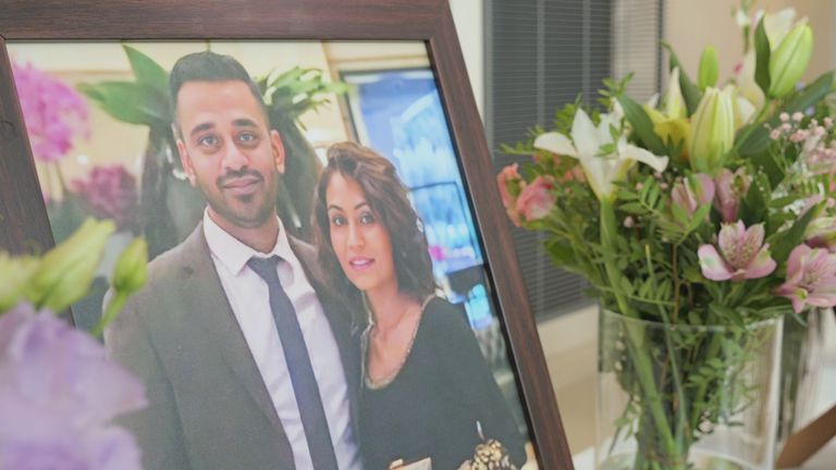 A photo of Sunny and Monali Patel, who died in the Air India plane crash, on display at a vigil