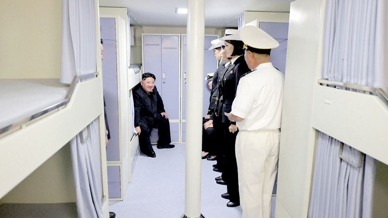 The North Korean leader sat on a bunk as he spoke to crew.
Pic: KCNA/AP