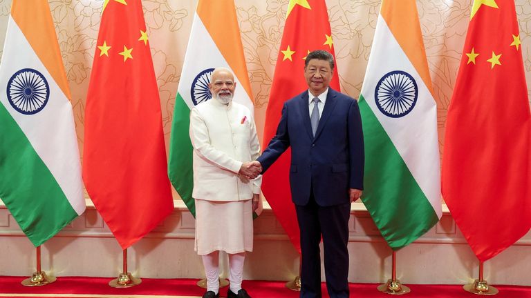India's PM Modi shakes hands with Xi Jinping. Pic: Reuters