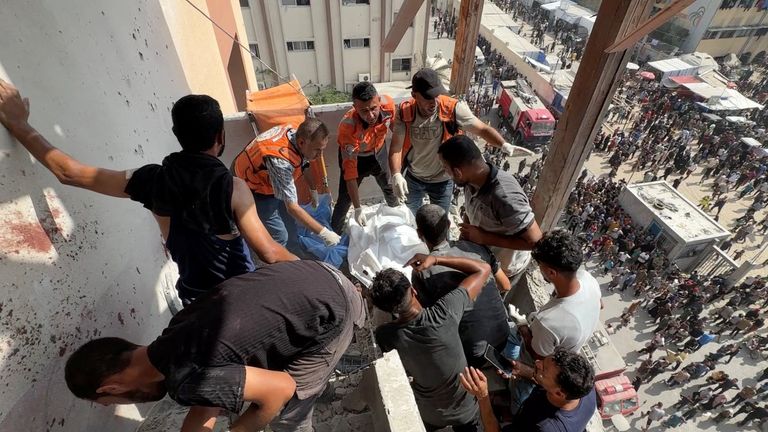 Rescuers work to recover the body of Palestinian cameraman Hussam al Masri. Pic: Reuters