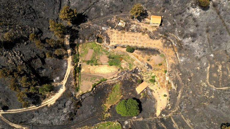 Structures surrounded by scorched land in the aftermath of a wildfire in Unhais da Serra, Covilha area, Portugal.
Pic: Reuters