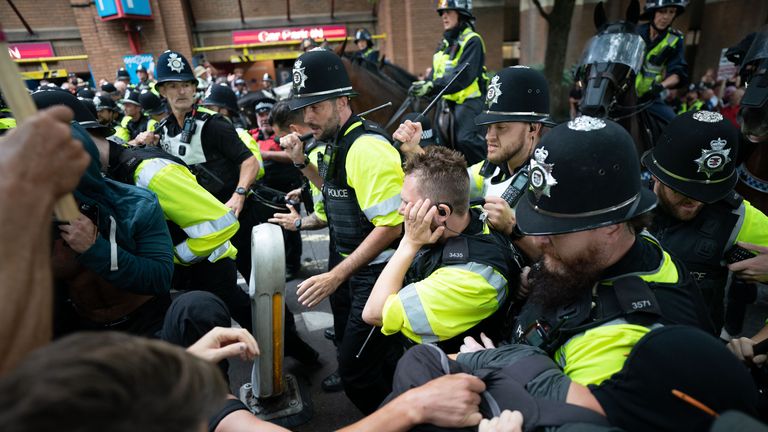 Police officers scuffle with demonstrators during protests at Castle Park in Bristol. Pic: PA