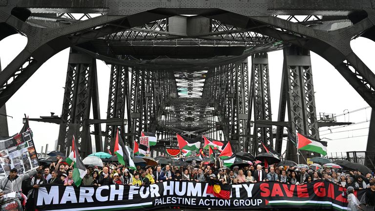 Protesters walk across the Sydney Harbour Bridge. Pic: AAP/Dean Lewins/Reuters