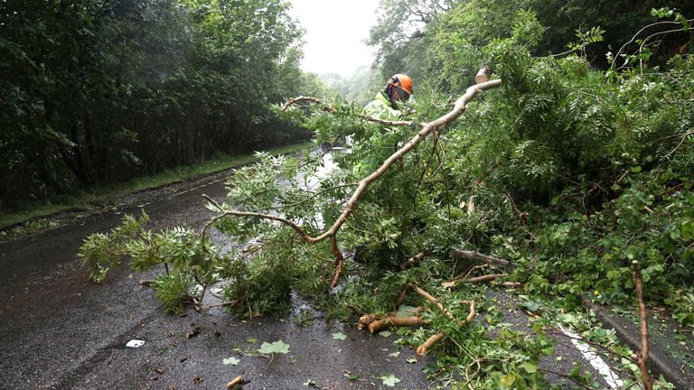 A worker removes a fallen tree blocking a part of the A82 road near Onich, as Storm Floris hits Scotland.
Pic: Reutetrs
