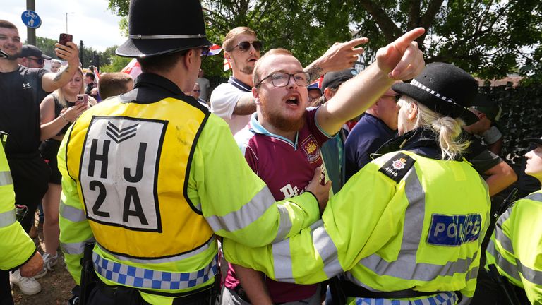 People take part in a protest outside the Sheraton Four Points Hotel in Horley, Surrey. Pic: PA