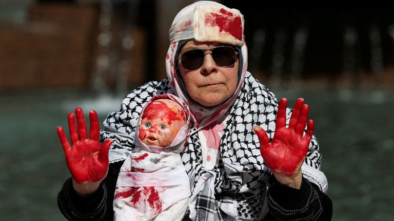 A demonstrator carries a doll during the Nationwide March for Palestine protest in Sydney on 24 August. Pic: Reuters