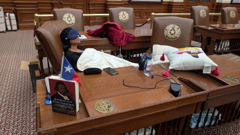 Nicole Collier sleeps in the House chamber after refusing a police escort. Pic: Reuters