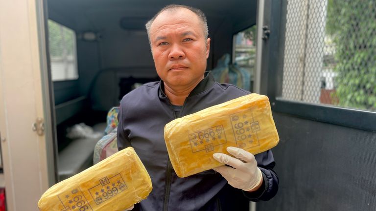 Lt Col Kantatat Yathoum, polis müfettişi, el ele geçirilmiş yaba tutuyor