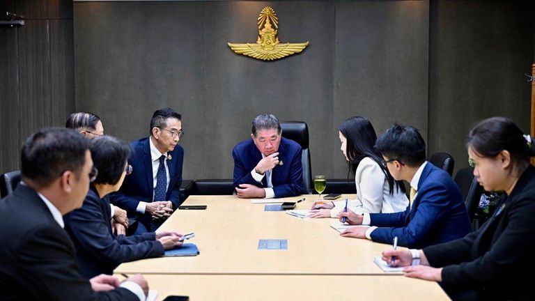 Thailand's acting Prime Minister Phumtham Wechayachai (centre) listens to a call with Donald Trump. Pic: AP