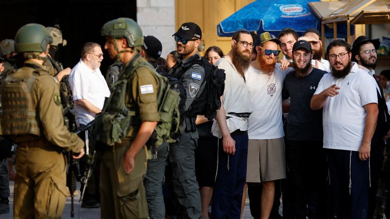 Israeli troops stand guard during a weekly settlers' tour in Hebron, in the Israeli-occupied West Bank. Pic: Reuters/Mussa Qawasma