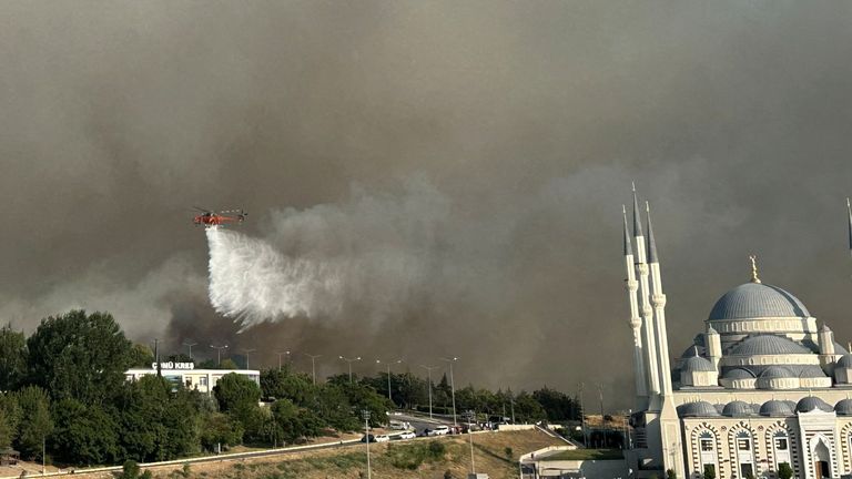 A firefighting helicopter in the Kepez district of Canakkale in Turkey. Pic: Reuters