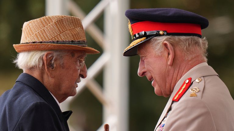 The King talks to war veteran Yavar Abbas. Pic: PA