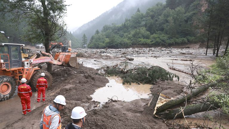 Rescuers at the site of mountain torrents in Yuzhong County. Pic: Xinhua/AP
