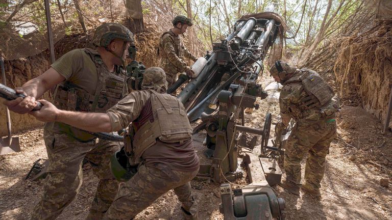 Ukrainian servicemen of the 148th artillery brigade load ammunition into a M777 howitzer before firing in Zaporizhzhia.
Pic: AP