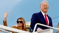 Donald Trump and  Melania Trump gesture as they board Air Force One.
Pic: Reuters