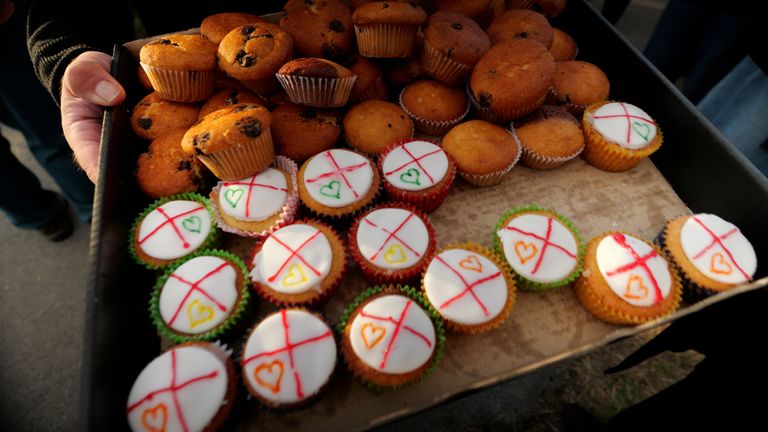 Cakes being handed out to protesters and counter-protesters by the Bishop of Kirkstall