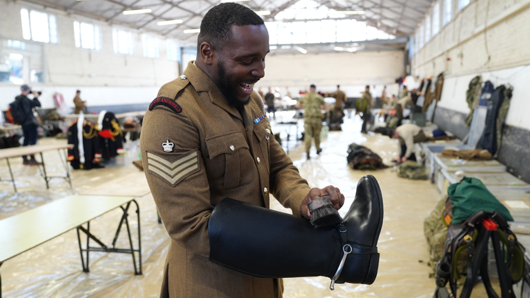 A member of the Blues and Royals prepares for a first ride-out ahead of rehearsals for the state visit. Pic: PA