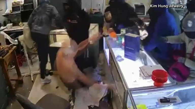 The eldery store owner was pushed over during the raid. Pic: NBC News/ Kim Hưng Jewelry