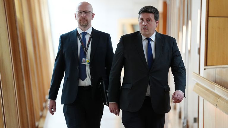 Jamie Hepburn alongside Colin McAllister, chief of staff at the Scottish government, on Thursday. Pic: PA