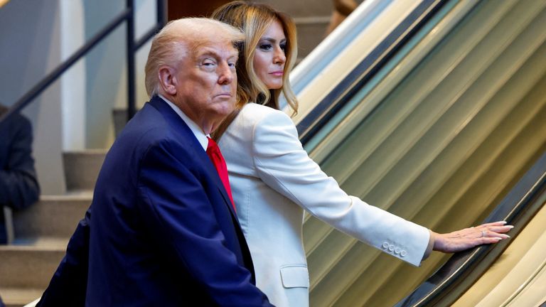Donald Trump and his wife Melania walked up the escalator after it stopped. Pic: Reuters