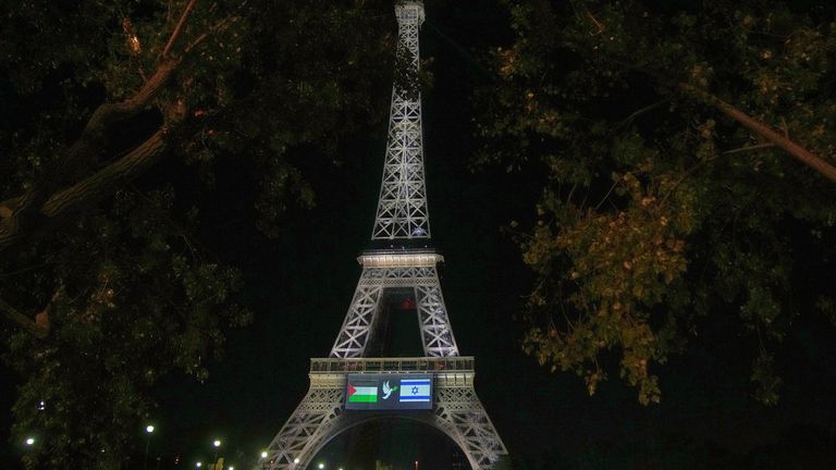 Flags of Palestine and Israel are projected onto the Eiffel Tower. Pic: AP/Christophe Ena