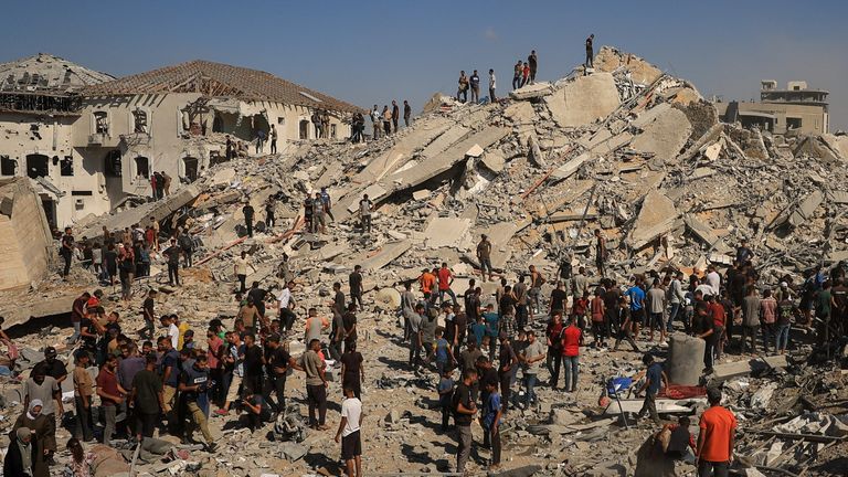 Palestinians inspect the site of a collapsed building in Gaza City after an Israeli strike on Monday. Pic: Reuters