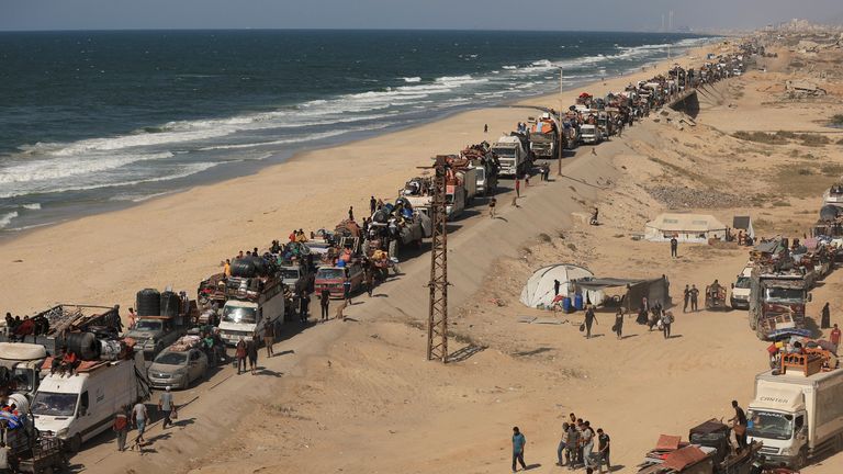 Displaced Palestinians flee southward in the central Gaza Strip after Israeli forces ordered residents of Gaza City to evacuate to the south