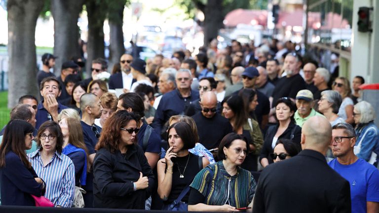 Mourners queue outside Armani Theatre in Milan