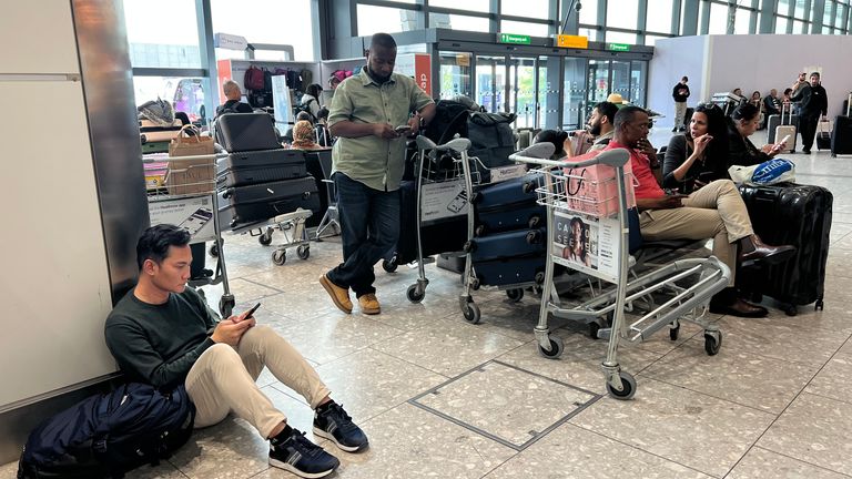 Passengers wait for news at Heathrow Terminal 4. Pic: PA