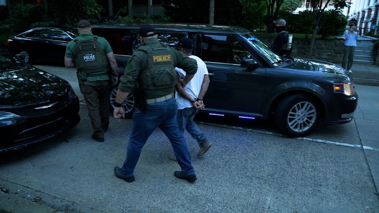 A man being detained during an ICE raid in  Washington DC