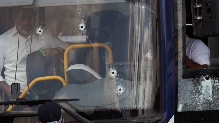 The bus with bullet holes in the windscreen. Pic: Reuters