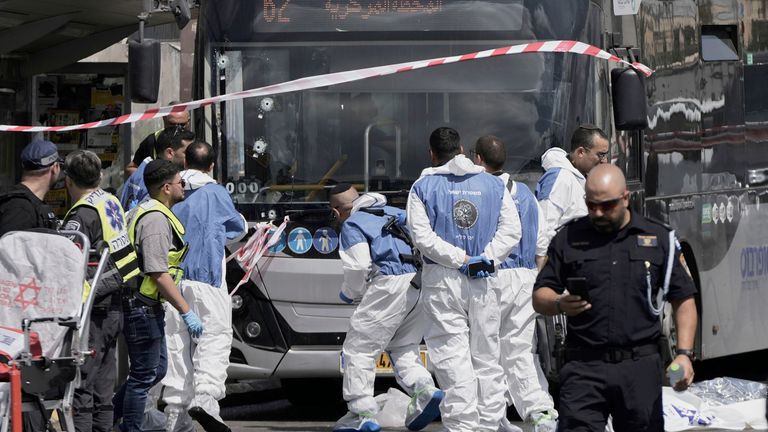 Emergency workers inside a cordon after the shooting. Pic: AP