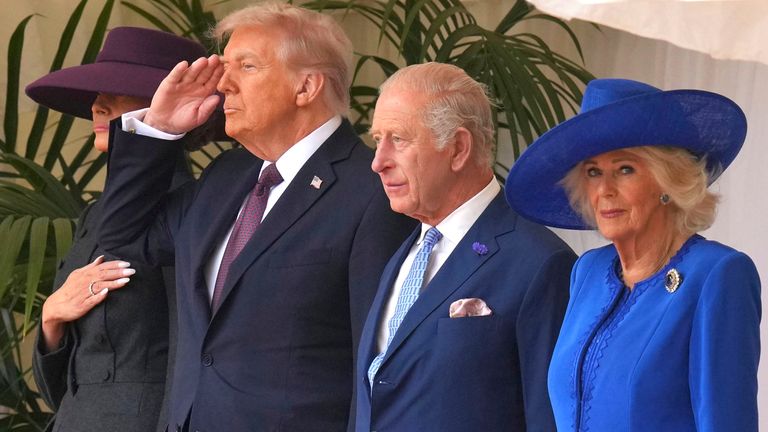 Donald Trump salutes troops as Queen Camilla's eye catches the camera. Pic: Kirsty Wigglesworth/PA Wire