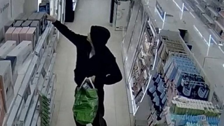 Hutchinson stealing from shelves in Boots on CCTV. Pic: Met Police