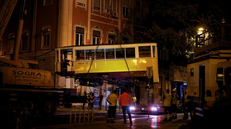 The second carriage is lifted from the crash site to be removed overnight on Thursday. Pic: Reuters